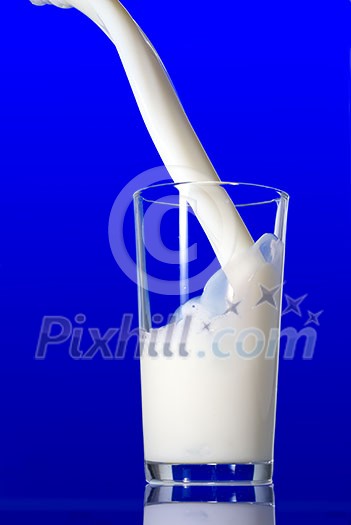 Milk splash isolated on blue Milk splash isolated on blue
