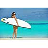 happy young beautiful asian woman relax on sand at tropical beach with cristal clear sea in background