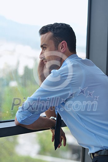 business man talking by cellphone in office