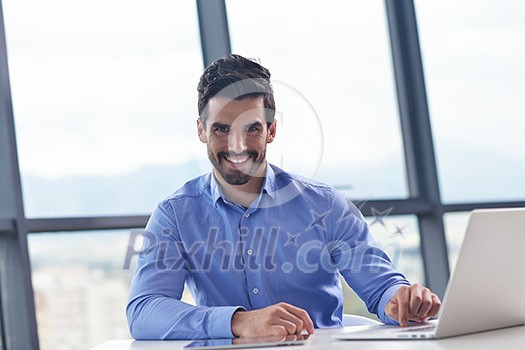 happy young business man work in modern office on computer happy young business man work in modern office on computer