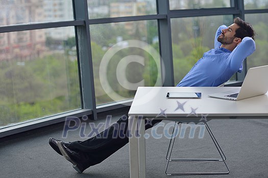 happy young business man work in modern office on computer happy young business man work in modern office on computer