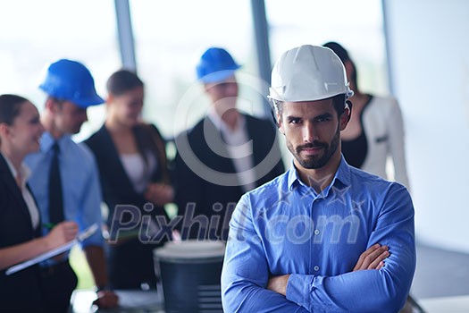 business people group on meeting and presentation in bright modern office with construction engineer architect and worker looking building model and blueprint planbleprint plans business people group on meeting and presentation in bright modern office with construction engineer architect and worker looking building model and blueprint planbleprint plans