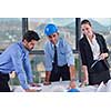 business people group on meeting and presentation  in bright modern office with construction engineer architect and worker looking building model and blueprint planbleprint plans