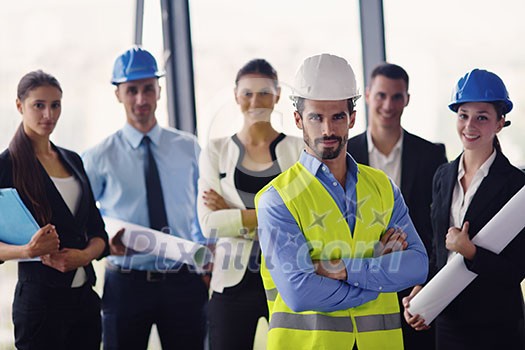 business people group on meeting and presentation in bright modern office with construction engineer architect and worker looking building model and blueprint planbleprint plans business people group on meeting and presentation in bright modern office with construction engineer architect and worker looking building model and blueprint planbleprint plans