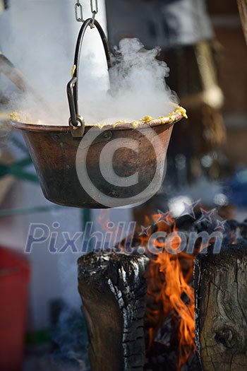 polenta food prepared on traditional recipe with fire and woods on height mountain alps at winter season at beautiful sunny day