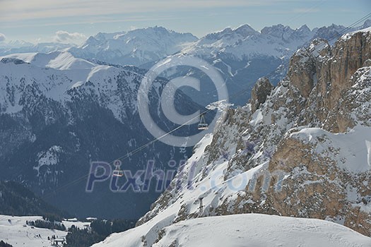 winter landscape with ski chairlift cabin and mountain covered with snow at sunny day winter landscape with ski chairlift cabin and mountain covered with snow at sunny day