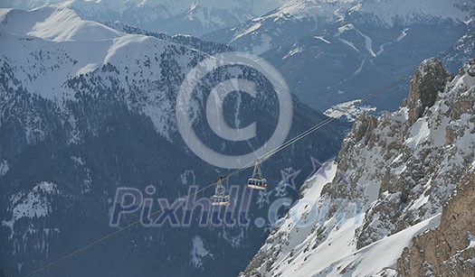 winter landscape with ski chairlift cabin and mountain covered with snow at sunny day winter landscape with ski chairlift cabin and mountain covered with snow at sunny day