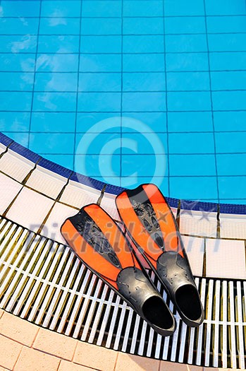 Scuba on the edge of outdoor swimming pool Scuba on the edge of outdoor swimming pool