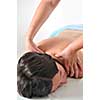 back massage at the spa and wellness center with beautiful brinette woman