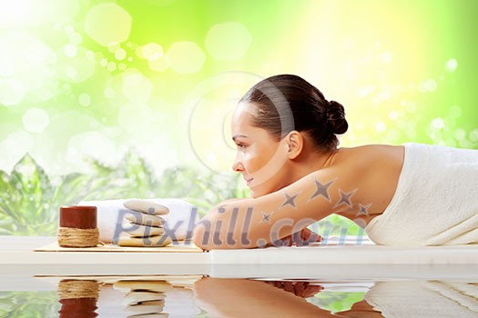 Image of young woman relaxing in spa salon