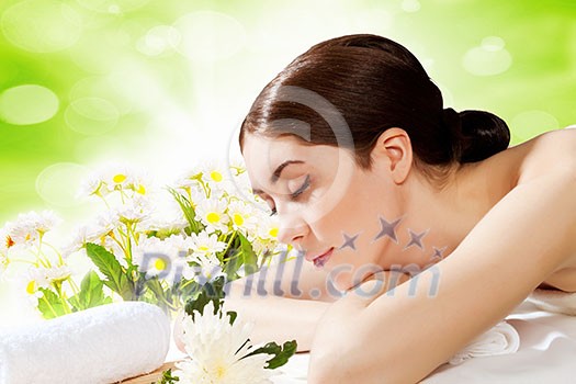Image of young woman relaxing in spa salon