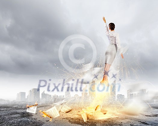 Image of businesswoman flying up into sky