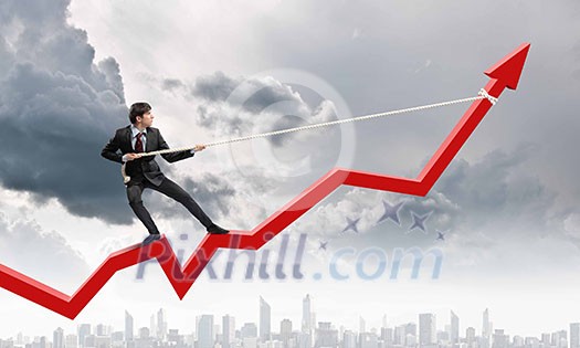Image of businessman standing on graph and pulling it upwards Image of businessman standing on graph and pulling it upwards