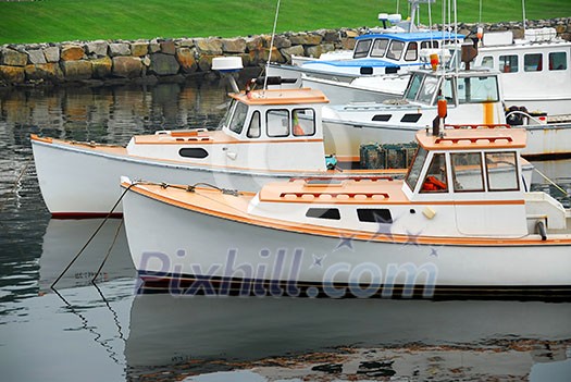 Fishing boats in a harbor in Perkins Cove, Maine Fishing boats in a harbor in Perkins Cove, Maine