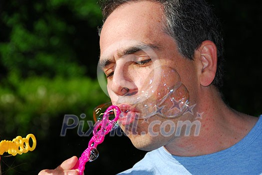 Man blowing soap bubbles