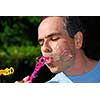 Man blowing soap bubbles