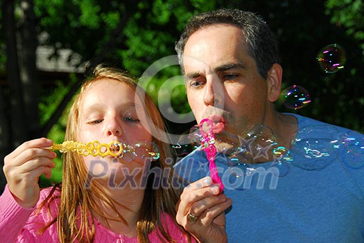 Happy family blowing soap bubbles