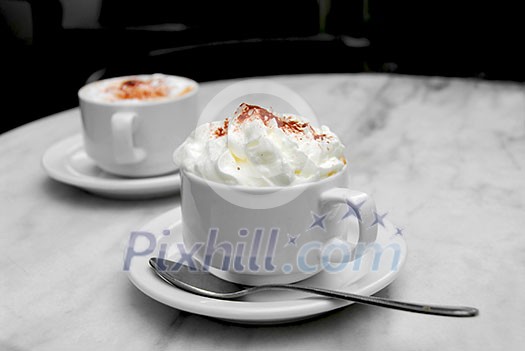 Two cups of coffee on a table Two cups of coffee on a table
