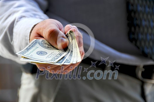 Hand of a businessman offering money