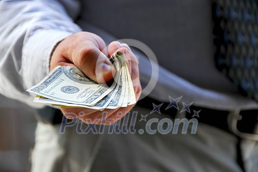 Hand of a businessman offering money Hand of a businessman offering money