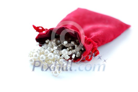 Pearls in red pouch on white background Pearls in red pouch on white background