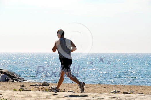 Man jogging in a beach Man jogging in a beach