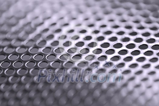Abstract background of perforated metal with very shallow dof Abstract background of perforated metal with very shallow dof