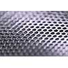 Abstract background of perforated metal with very shallow dof