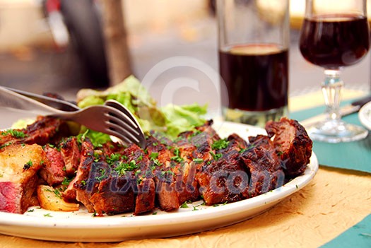 Plate of roasted beef and red wine