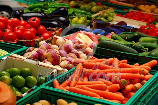 Fresh assorted vegetables in boxes on farmer's market