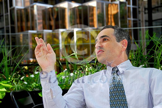 Businessman calling a waiter in outdoor cafe Businessman calling a waiter in outdoor cafe