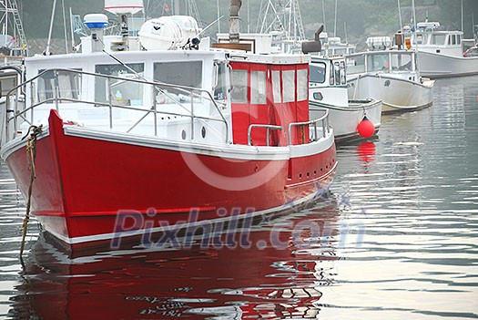 Fishing boats in a harbor in Perkins Cove, Maine, at dusk