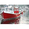 Fishing boats in a harbor in Perkins Cove, Maine, at dusk