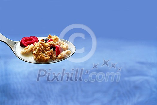 Spoon of cereal on blue background