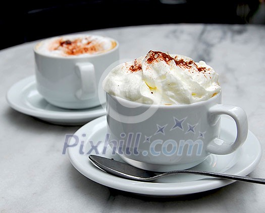 Two cups of specialty coffee on a table