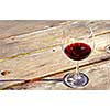 Glass of red wine on old rustic table