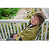 Senior woman sitting on a porch and smiling
