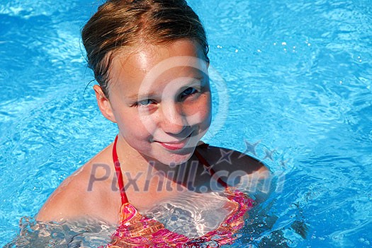 Young girl in a swimming pool Young girl in a swimming pool