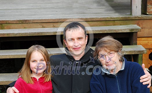 Daughter, father and grandmother on the deck stairs Daughter, father and grandmother on the deck stairs