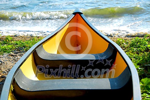 Yellow canoe on lake shore Yellow canoe on lake shore