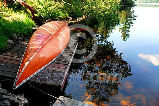 Canoe on wooden dock on a lake