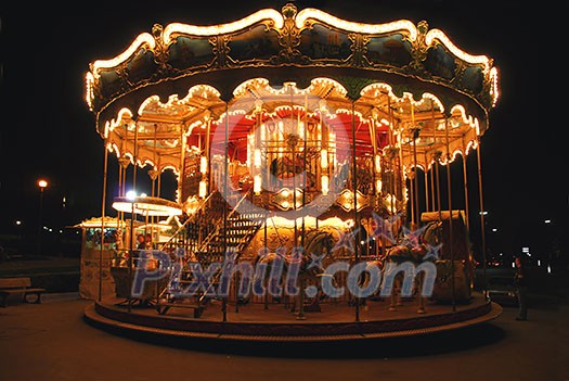 Brightly illuminated traditional carousel in Paris France at night Brightly illuminated traditional carousel in Paris France at night