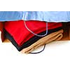 Folded sweaters in a paper shopping bag on white background