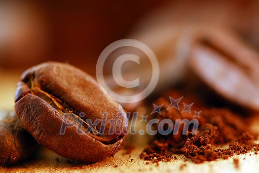 Macro image of coffee beans and ground coffee Macro image of coffee beans and ground coffee