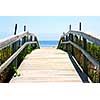 Wooden path over sand dunes with ocean view