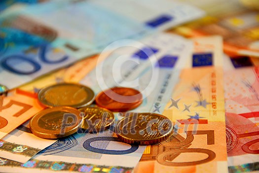 Background of bills and coin of european union currency, shallow dof