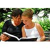 Grandmother and granddaughter reading a book