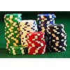 Stacks of gambling chips on green background