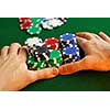 Poker player going 'all in' pushing his chips forward