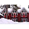 Log building of a mountain lodge in winter at ski resort